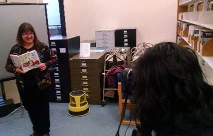 Harriet getting her picture taken for a READ poster at the Alaska State library.