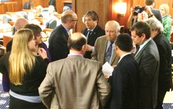 Rep. Drummond (left) confers with caucus members during the floor vote on House Bill 384.