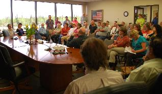 Rep Guttenberg and Rep Wool talk with residents during a packed constituent meeting.
