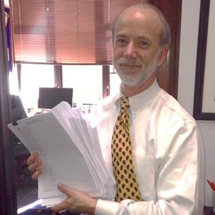 Senator French holds up the stacks of letters written in opposition to HB 77