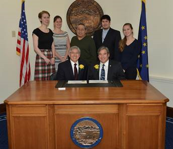 Left: Rep. Kito signs his oath of office with Lt. Governor Byron Mallott with family and staff in attendance.