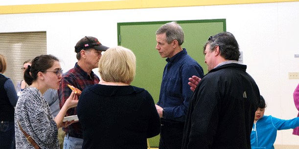 Rep. Claman talks with a group of constituents while some enjoy Uncle Joe’s pizza!