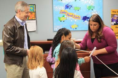 Rep. Claman helps give the morning announcements at Lake Hood Elementary School.
