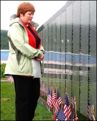 Representative Gardner reflects in front of the Moving Wall in Eagle River.