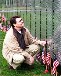 Representative Gardner reflects in front of the Moving Wall in Eagle River.