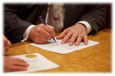 Representative Guttenberg signs his oath of office