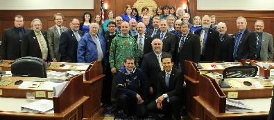 Representatives wearing blue on the House Floor in support of ending child abuse 