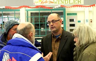 Talking with neighbors after the Wendler meeting and pizza party