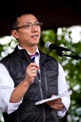 Rep. Kawasaki speaking outdoors