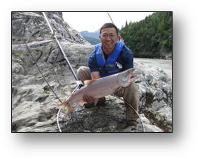 Rep. Kawasaki showing off a red salmon caught during an annual Chitina fishing trip.