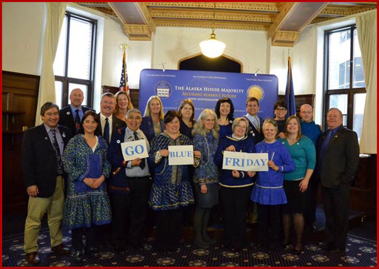 Sam stands with other Representatives and House clerks dressed in blue for Wear Blue Day to show support for child abuse awareness. 