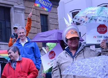 April 28, 2015: We might not celebrate the continuation of the Session, but we did get a flashmob at the “Stop in the Name of Love” event. Rep. Kito and Rep. Claman rallied in the rain to support of LGBT equality – great music, great energy, and great company!