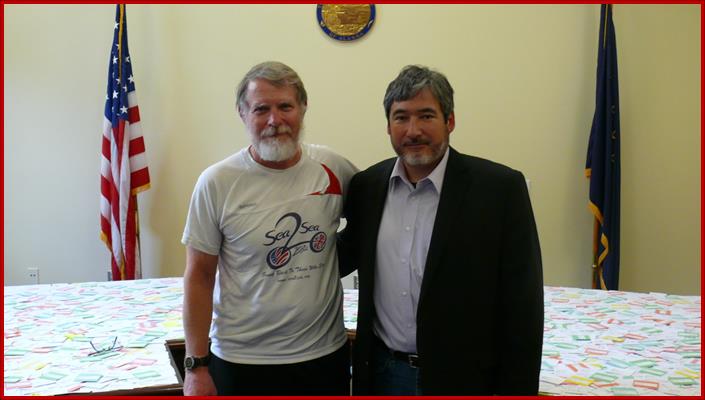 Sam participating in a ceremony to remember fallen Alaskan soldiers with Tom von Kaenel. After bicycling across America from Florida to Juneau, Tom wrapped up his tour with a ceremony in the Capitol to recognize Alaskans who died in Iraq and Afghanistan.