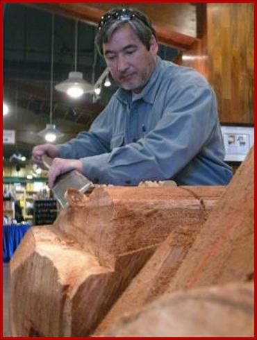 Sam taking a turn at carving a totem pole. 