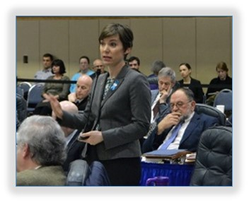 Rep. Spohnholz speaking on SB 91 in the temporary chamber of the House located in an old school gymnasium