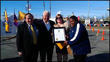 Rep. Tarr is joined by Jim Balamaci, center, the President/CEO of Special Olympics Alaska, after the ribbon cutting event.