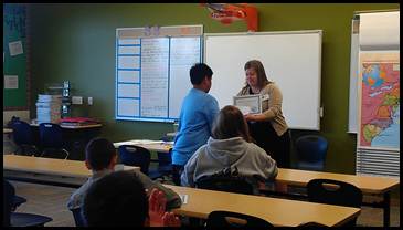 Right: Rep. Tarr presents the certificates to students at Clark.