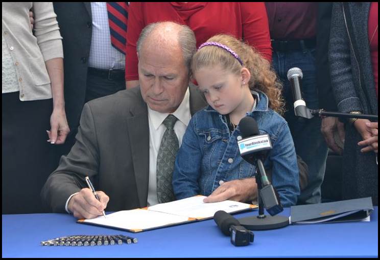 Governor Walker signs the bill into law. 