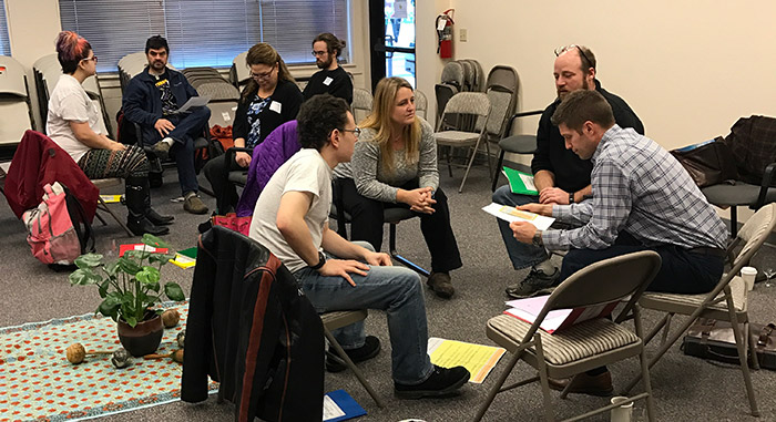 Attendees work in small groups to discuss school environment and restorative practices.