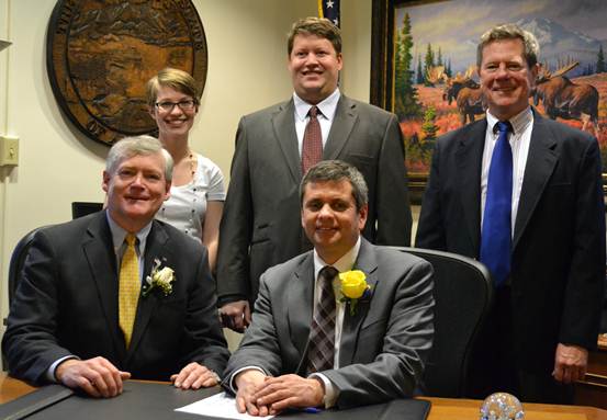 Rep. Tuck signs the Oath of Office with Lt. Governor Mead Treadwell, joined by staff members Kaycie Thompson, George Ascott, and Mike Coumbe.