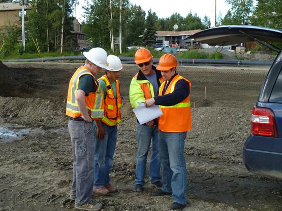 Rep. Tuck studying road construction plans on a recent tour of the West Dowling Upgrade.