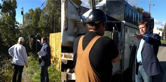 Left: A neighbor informs Rep. Tuck about a dangerous situation in which a large tree has fallen on a power line. Right: Rep. Tuck talks with the utility crew after reporting the problem. 
