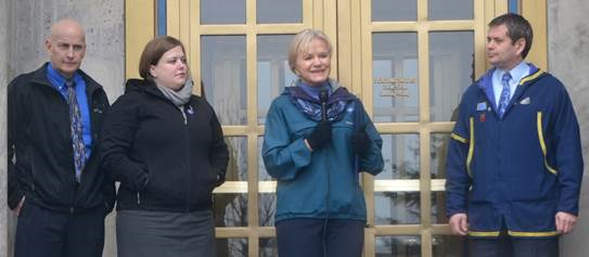 Rep. Chris Tuck, far right, joins First Lady Donna Walker and Reps. Geran Tarr and Dan Ortiz for a Go Blue Friday rally on the Capitol steps