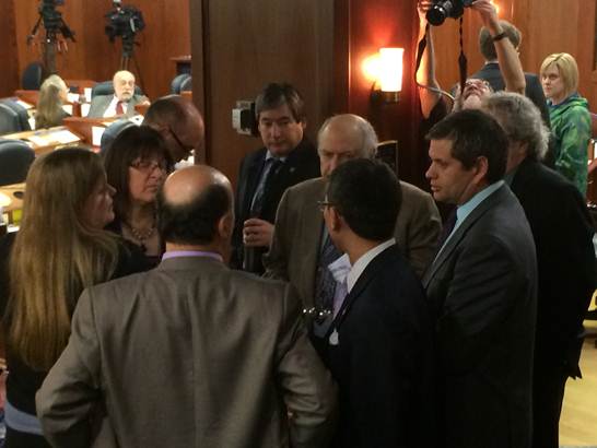 Rep. Tuck (far right) confers with caucus members during the floor vote on House Bill 384.