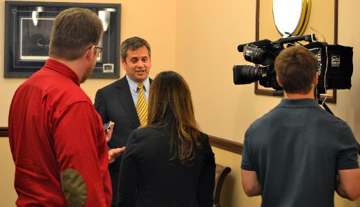 Rep. Chris Tuck is interviewed by paper and television journalists.