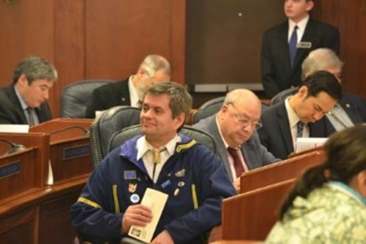 Rep. Chris Tuck reads one of the many constituent survey responses he received during the 2015 Alaska Legislature.