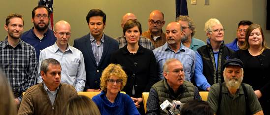 Rep. Chris Tuck, seated at far left, answers questions from the press with other members of the new House Majority.