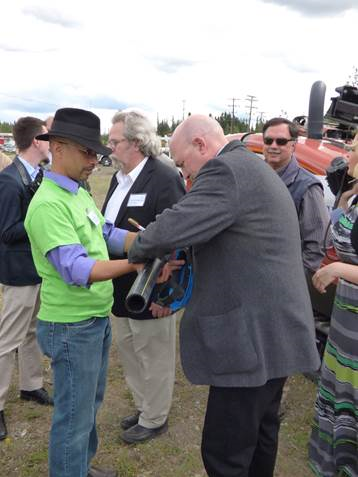Representative Wool signing the ceremonial first piece of pipe laid for the Interior Gas Utility